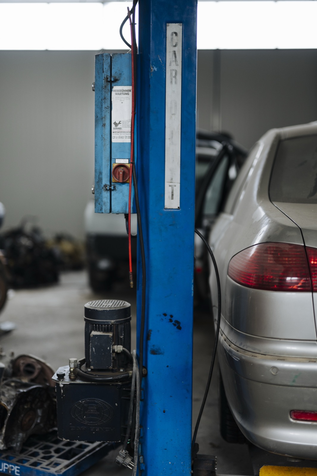 Car lift and tools in an auto repair shop